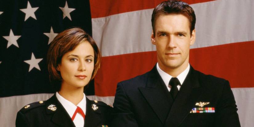 David James Elliott as Harmon Rabb Jr. and Catherine Bell as Sarah MacKenzie posing in front of an American flag for JAG
