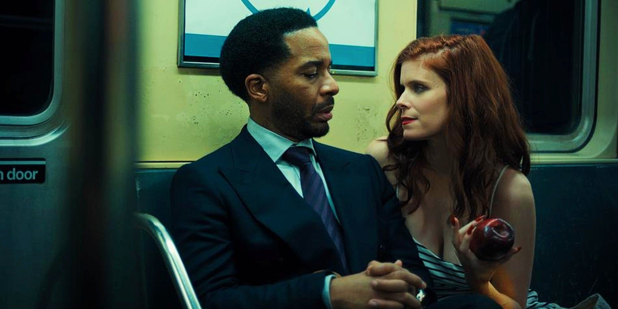Kate Mara offers Andre Holland an apple while sitting next to him on the Subway in The Dutchman