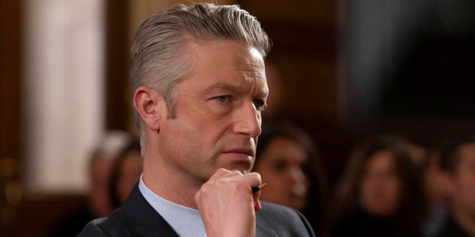 Carisi in the courtroom with his hand to his chin in Law & Order SVU