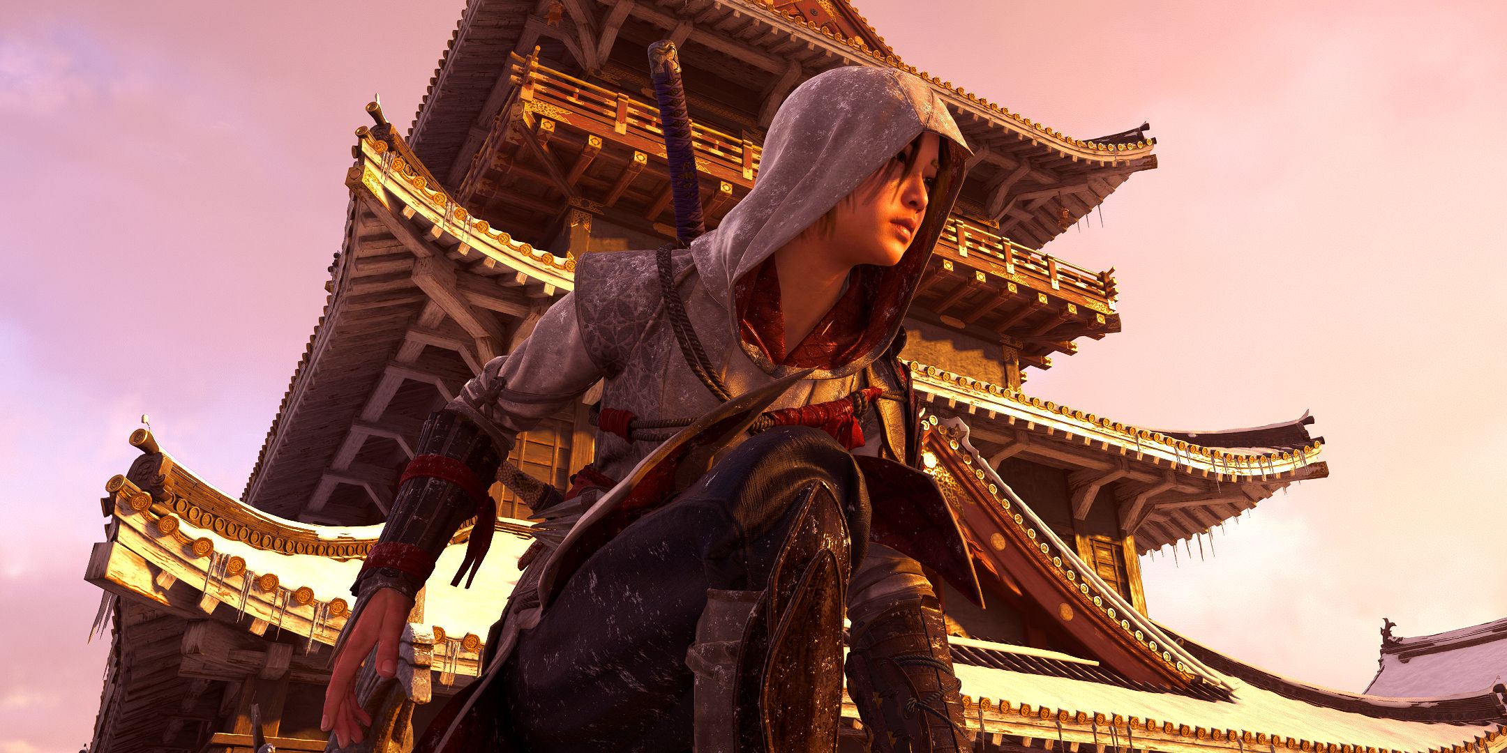 Naoe Takeda kneeling in front of a Castle in Assassin's Creed Shadows.
