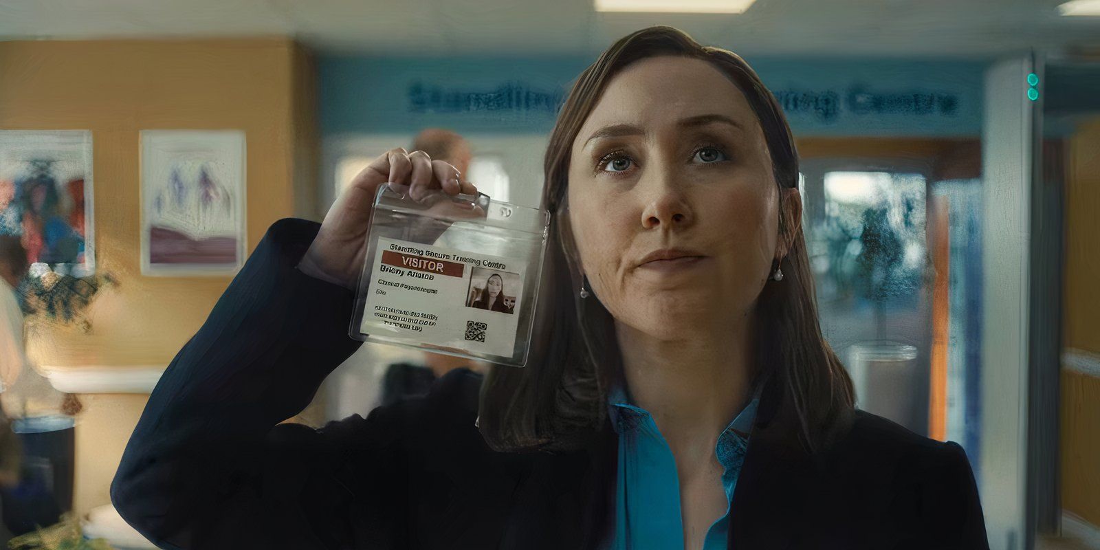Psychologist Briony holding up a photo ID in Adolescence