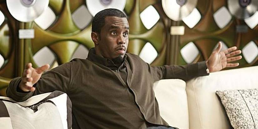 Sergio (Sean Combs) with his hands raised in front of records in Get Him to the Greek.