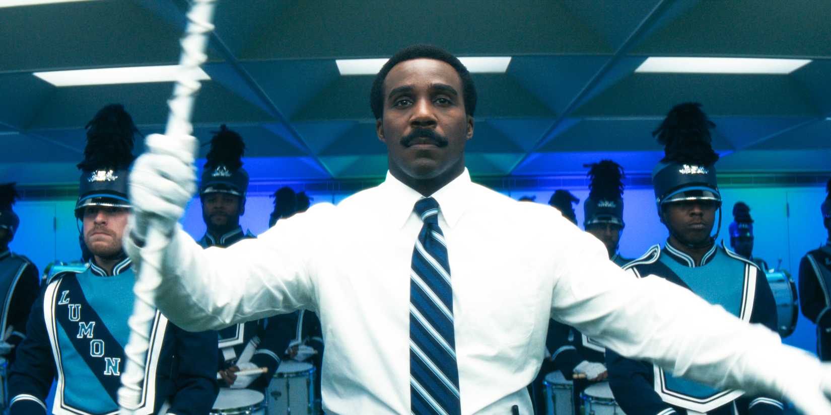 Milchick (Tramell Tillman) leading and dancing with the choreography and merriment band in Severance Season 2 Ep 10