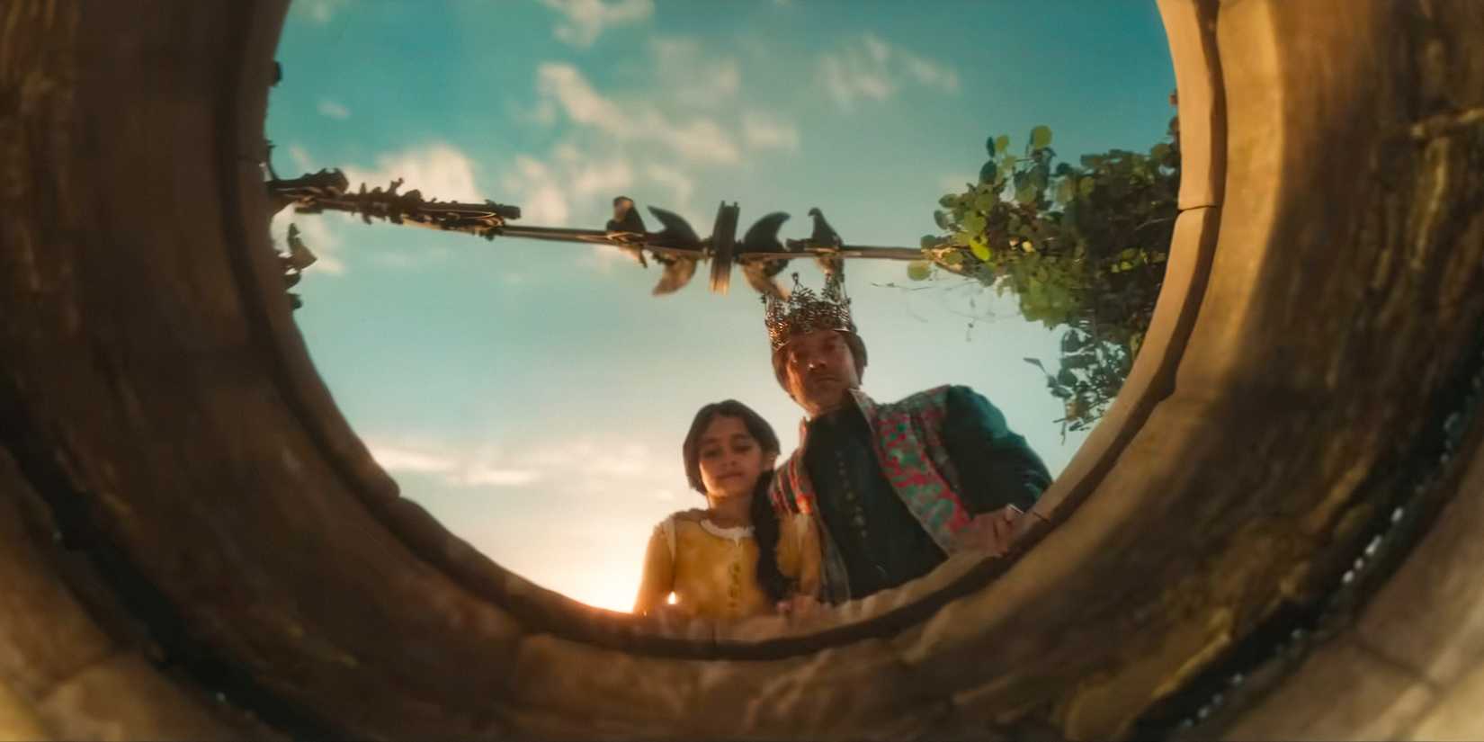 Good King (Hadley Fraser) and Young Snow White (Emilia Faucher) peering into a well in Snow White (2025)