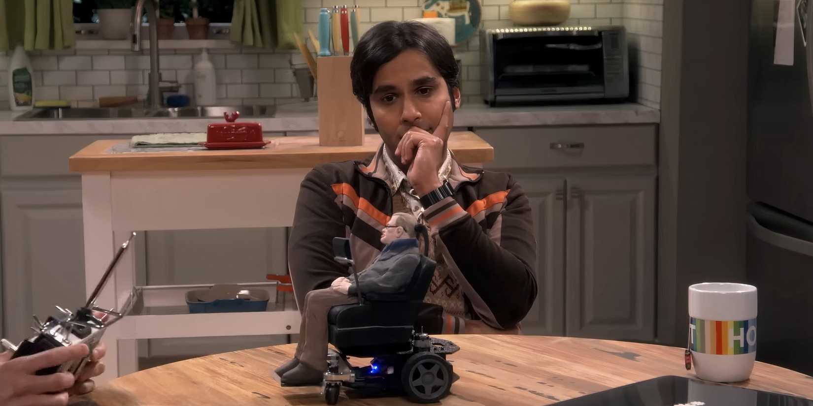 Kunal Nayyar as Rajesh Koothrappali with Howard's Stephen Hawking toy in The Big Bang Theory