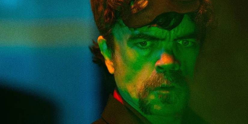 Winston Gooze looking at something green and glowing in The Toxic Avenger.