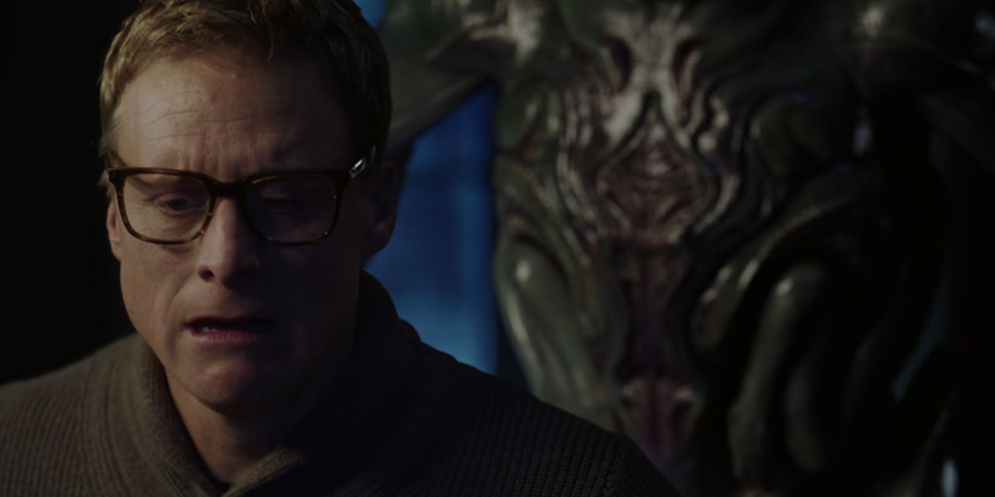 Human Harry with an alien behind him in Resident Alien