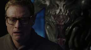 Human Harry with an alien behind him in Resident Alien