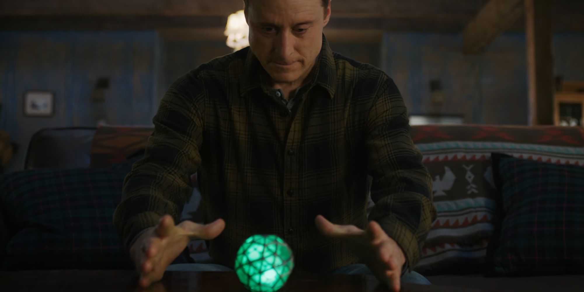 Harry admiring his device in Resident Alien