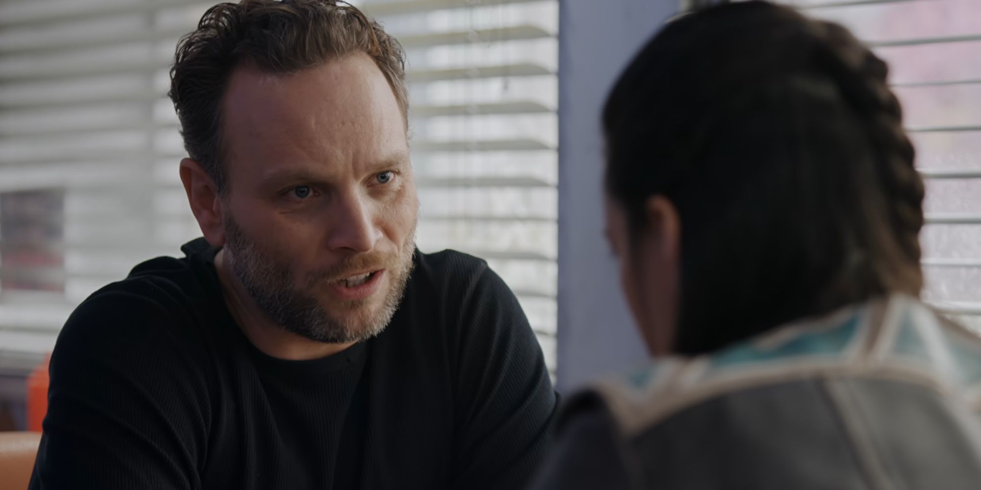 Asta speaking with her ex-husband in Resident Alien