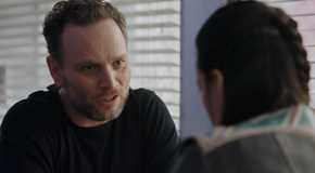 Asta speaking with her ex-husband in Resident Alien