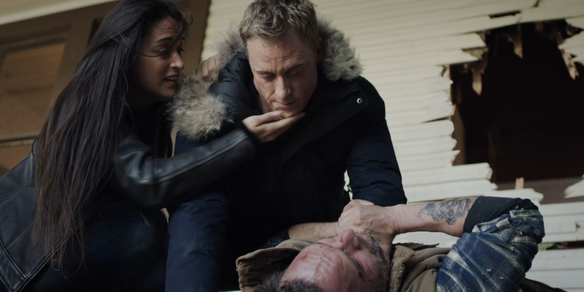 Harry choking someone in Resident Alien while Asta tries to stop him