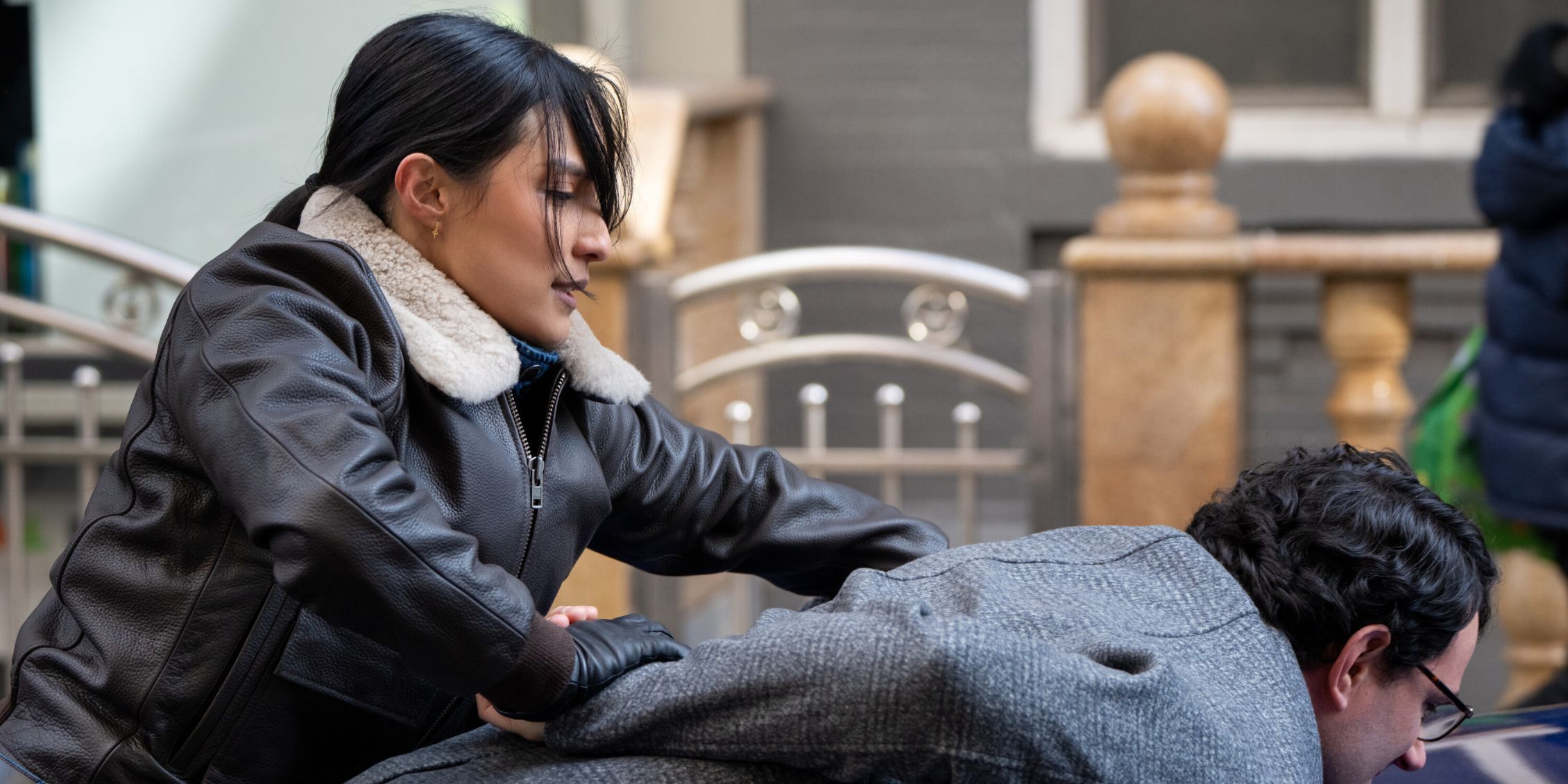 FBI close-up of Dani bending a suspect over a car and cuffing him