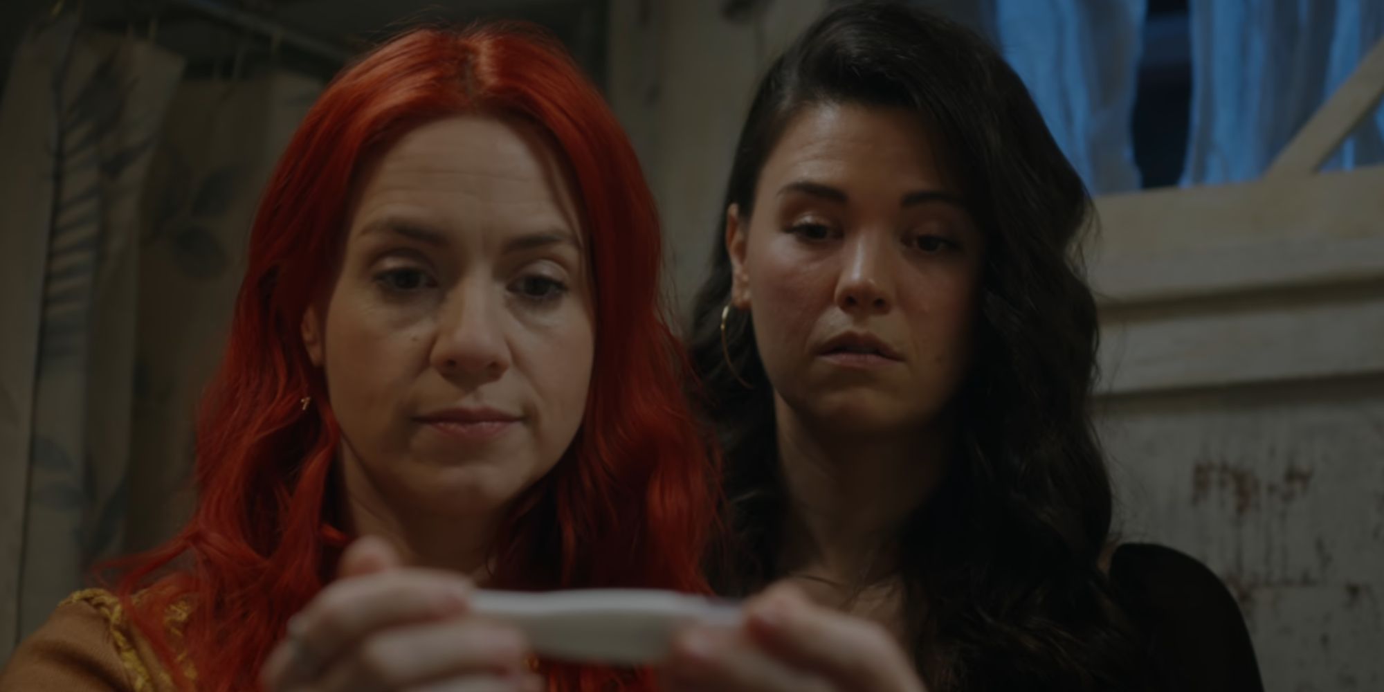 D'arcy and Kate looking at a pregnancy test in Resident Alien