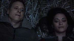 Harry and Asta on the ground looking at the stars in Resident Alien
