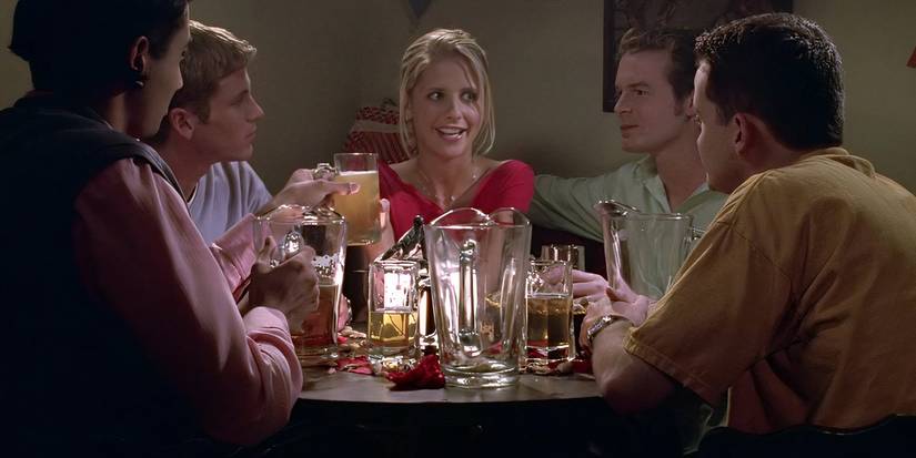 Buffy sitting at a table of college boys drinking beer in Buffy the Vampire Slayer Beer Bad