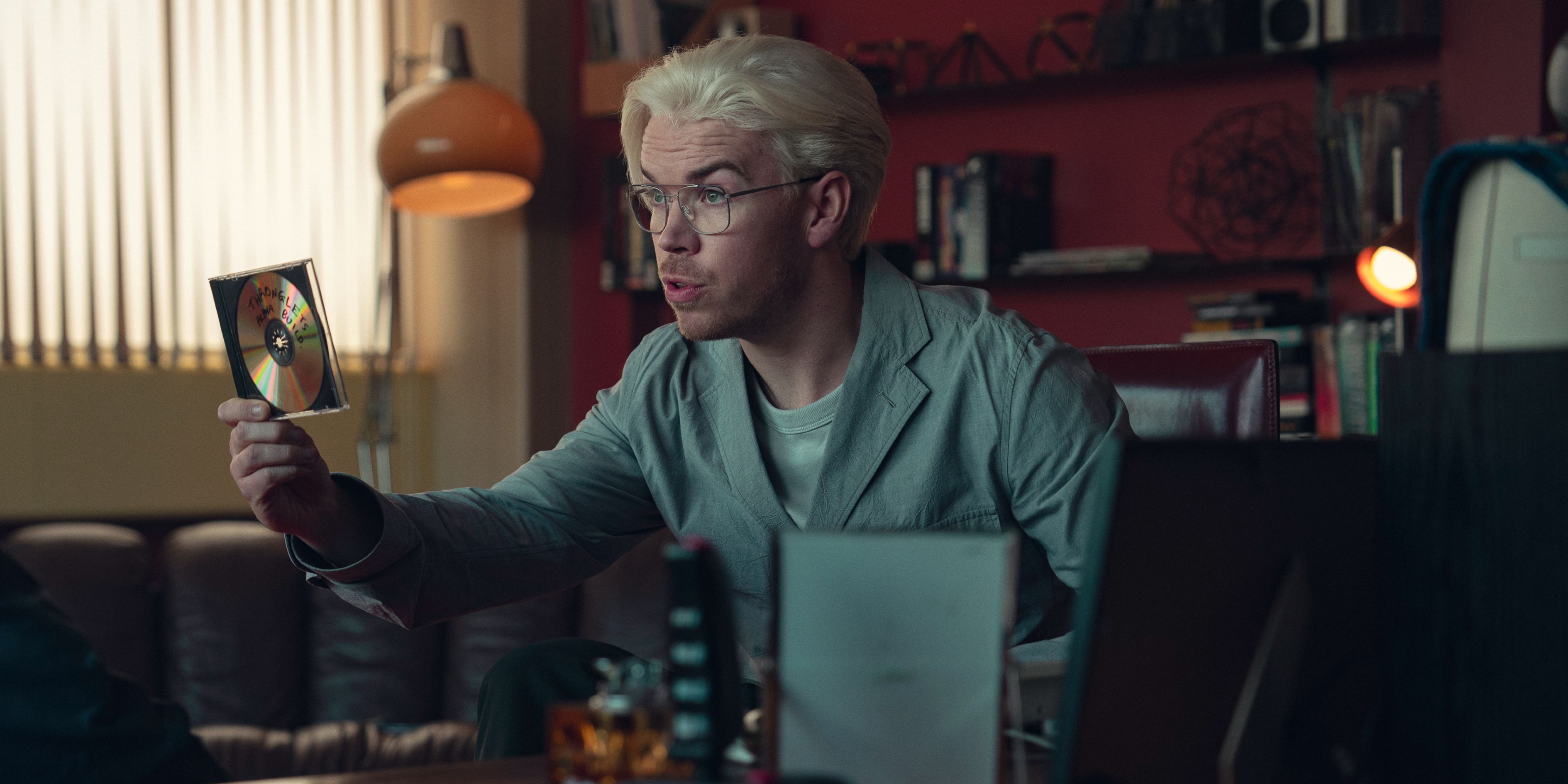 Colin Ritman holding up a disk of his new game in Black Mirror season 7 episode 4