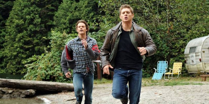 Sam and Dean running on a lake shore in Supernatural
