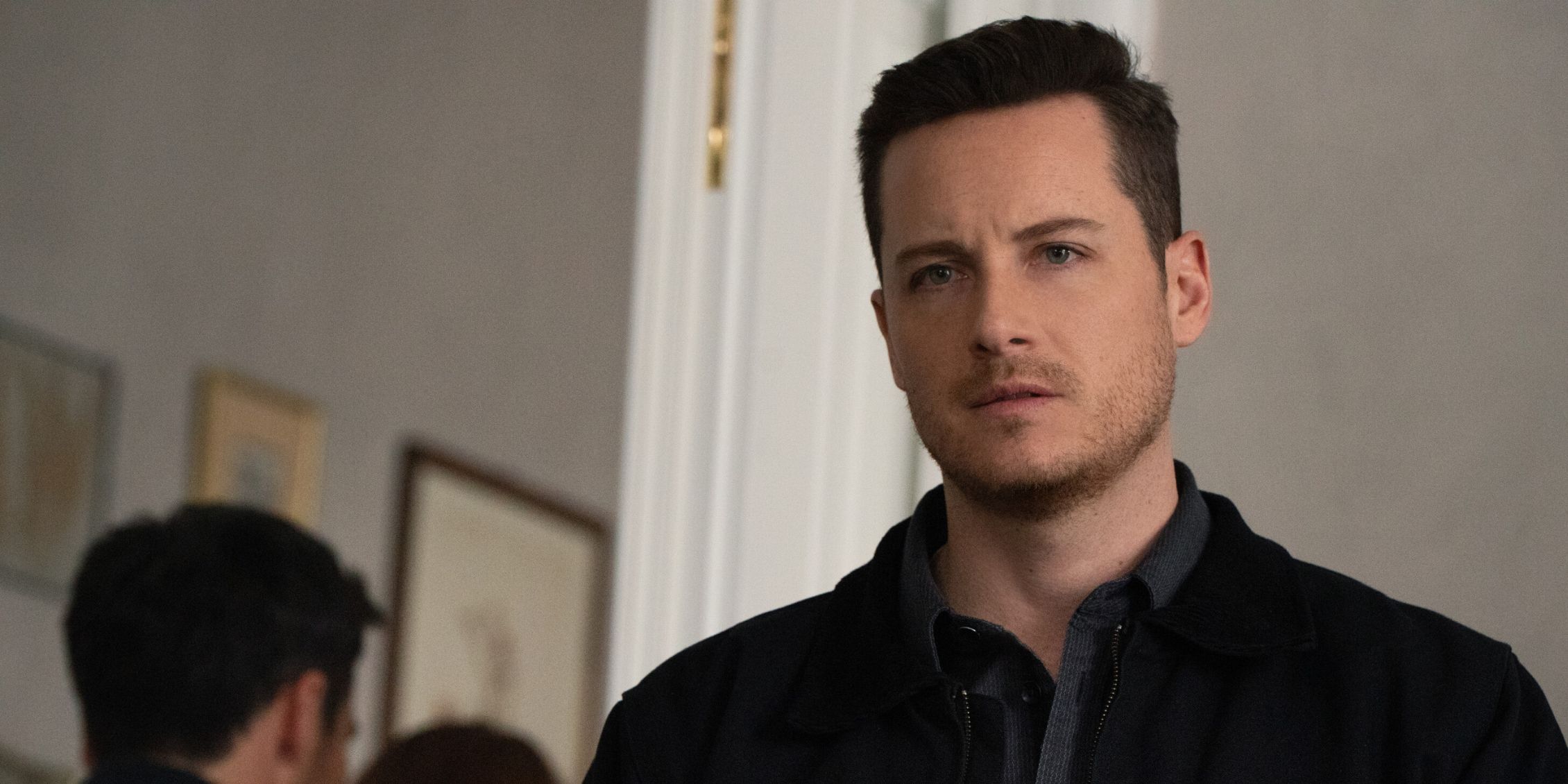 FBI International Wes Mitchell standing in a room staring at something