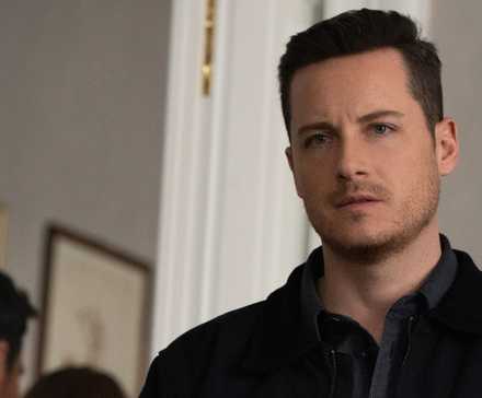 FBI International Wes Mitchell standing in a room staring at something