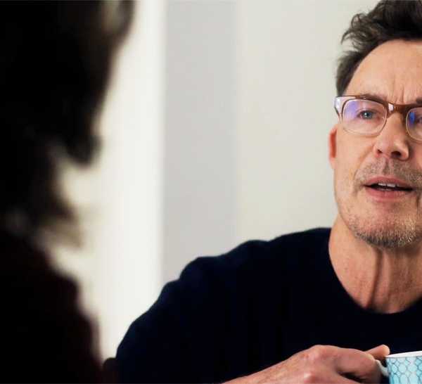 Isobel's husband holding a cup in FBI