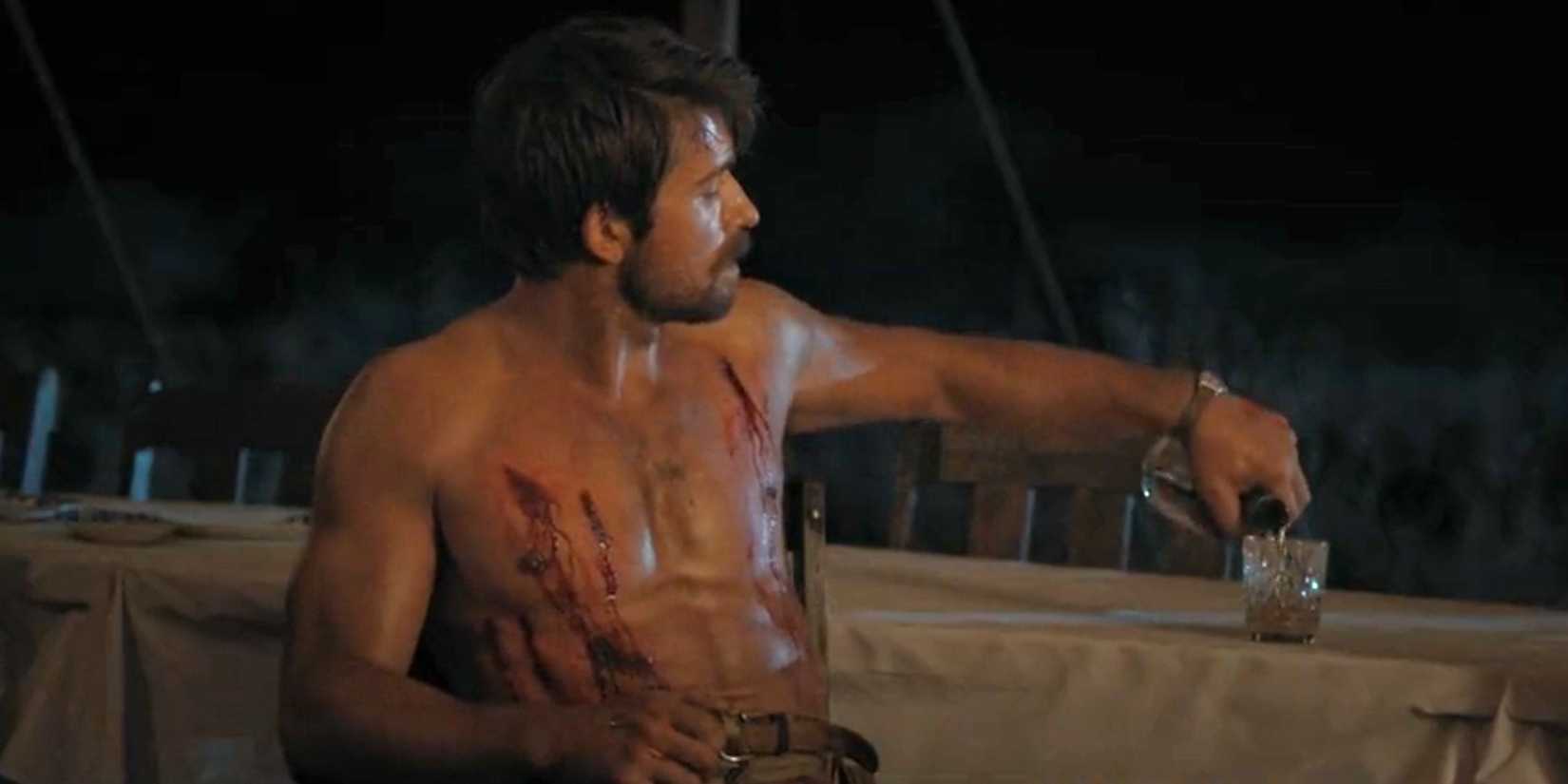 Spencer Dutton (Brandon Sklenar) with claw marks on his chest in 1923 season 1, episode 2