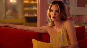Meghann Fahy as Devon looking serious while sitting on a couch in Sirens