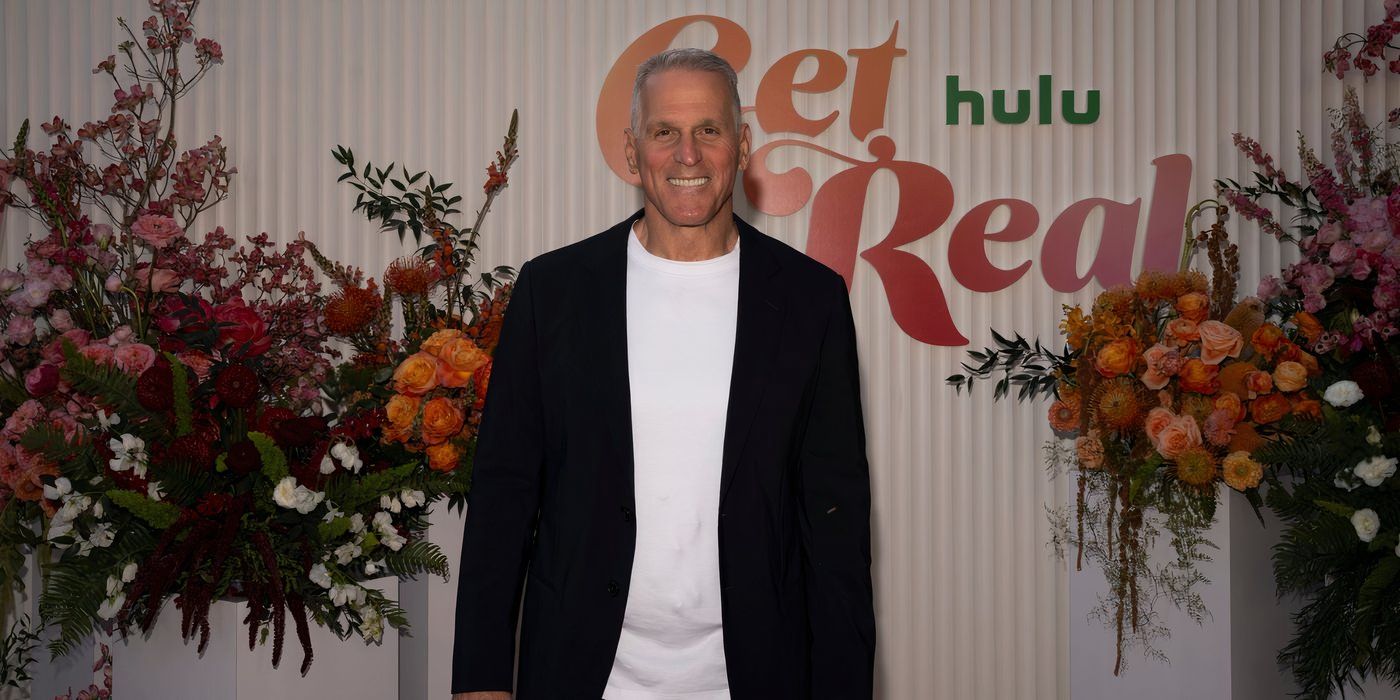 The Golden Bachelor's Mel Owens at a press event wearing a black suit jacket and white shirt