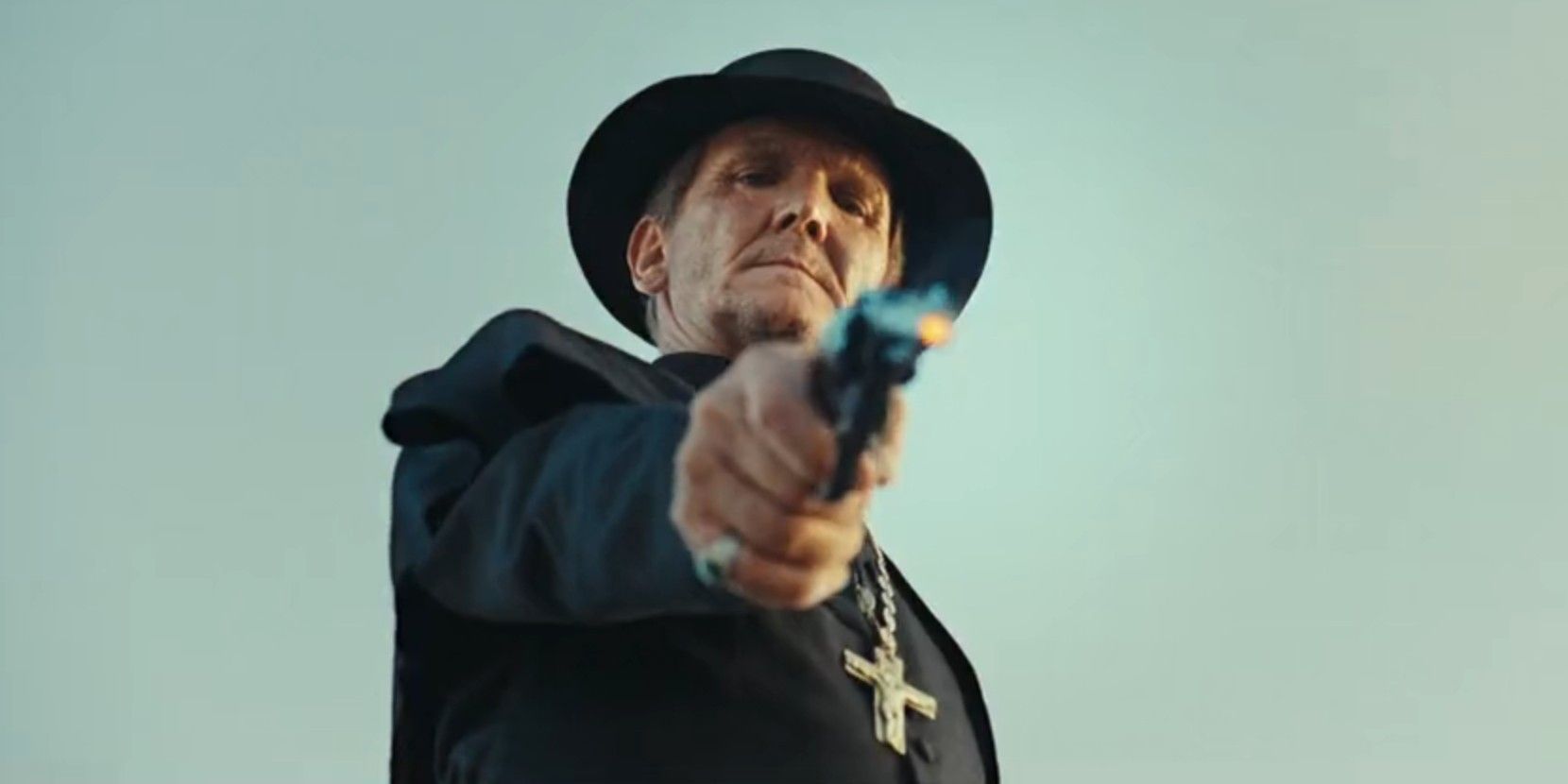 Father Renaud (Sebastian Roche) shooting a revolver in 1923 season 2, episode 6
