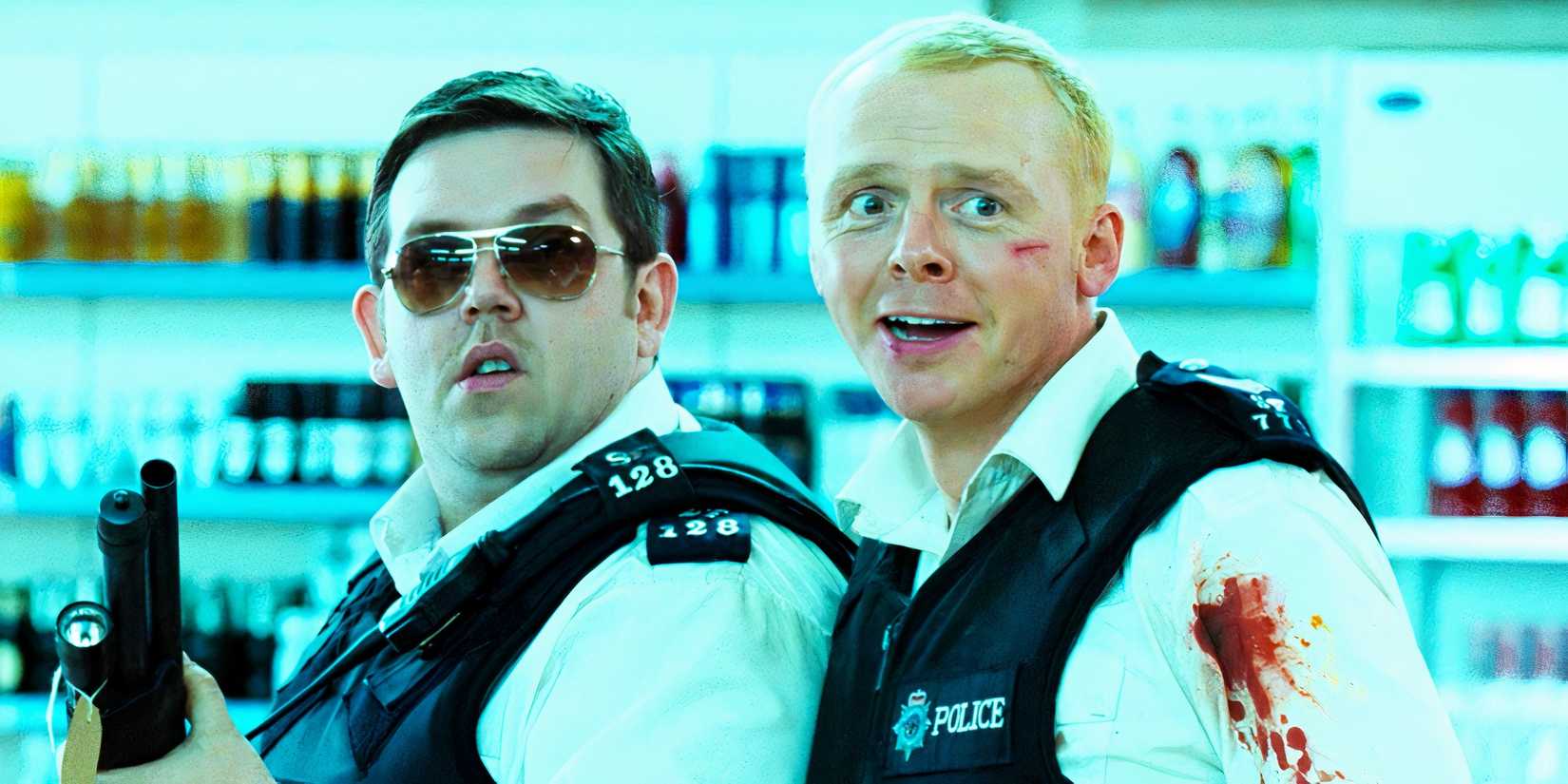 Simon Pegg smiling and Nick Frost looking serious with a gun in Hot Fuzz