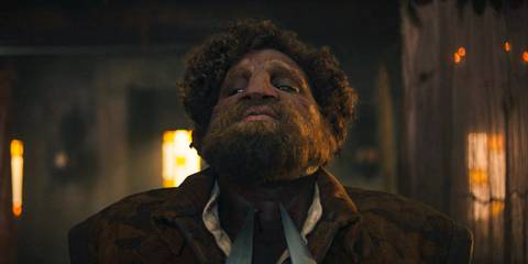 Loial (Hammed Animashaun) is pointed at the neck with two swords in The Wheel of Time Season 3 Ep 7