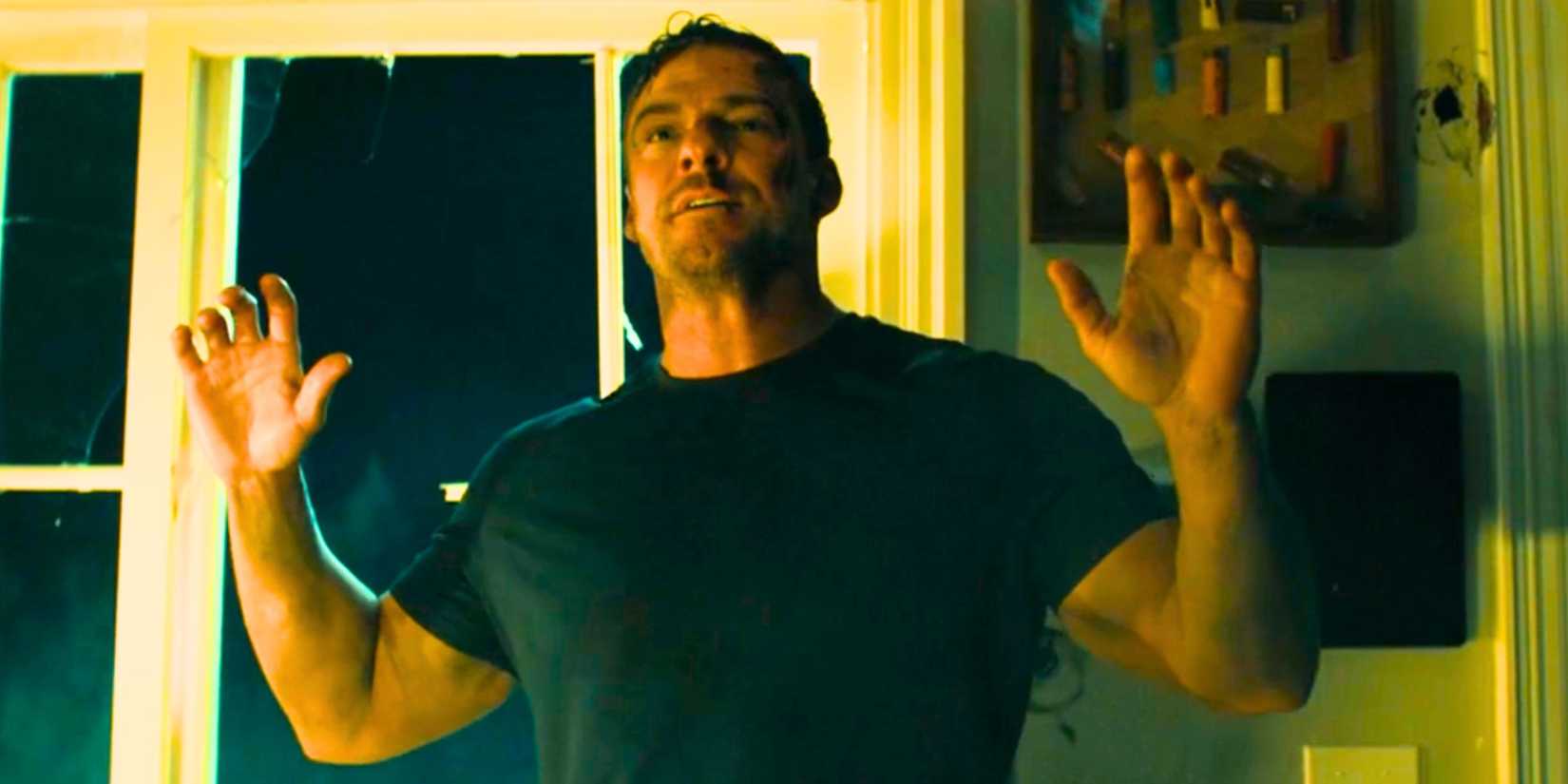 Alan Ritchson surrendering as Jack Reacher in Reacher