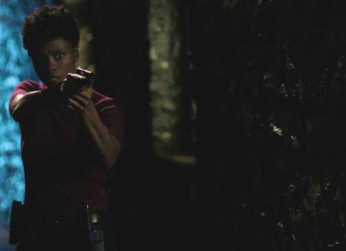 Katherine Renee Kane as Tiffany in FBI, pointing her gun in a dark alleyway