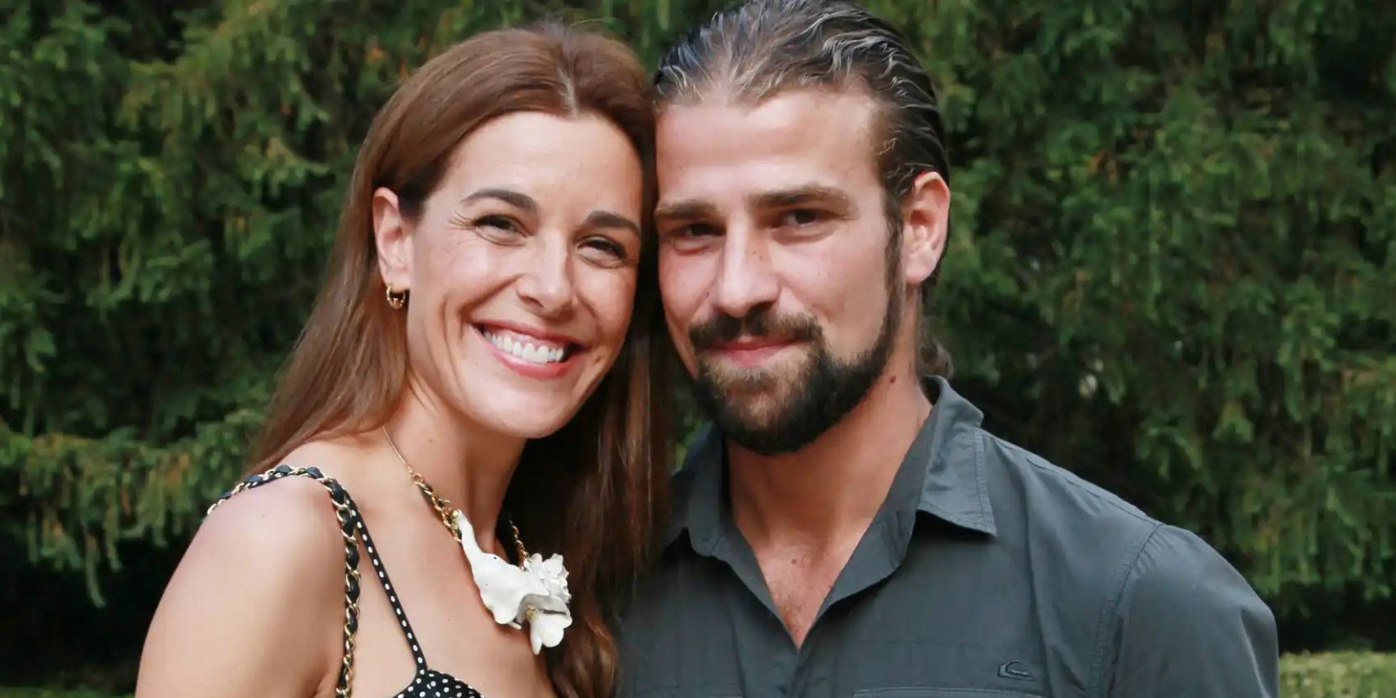 Raquel Sanchez-Silvia smiling with Mario Biondo, their heads touching and looking into the camera