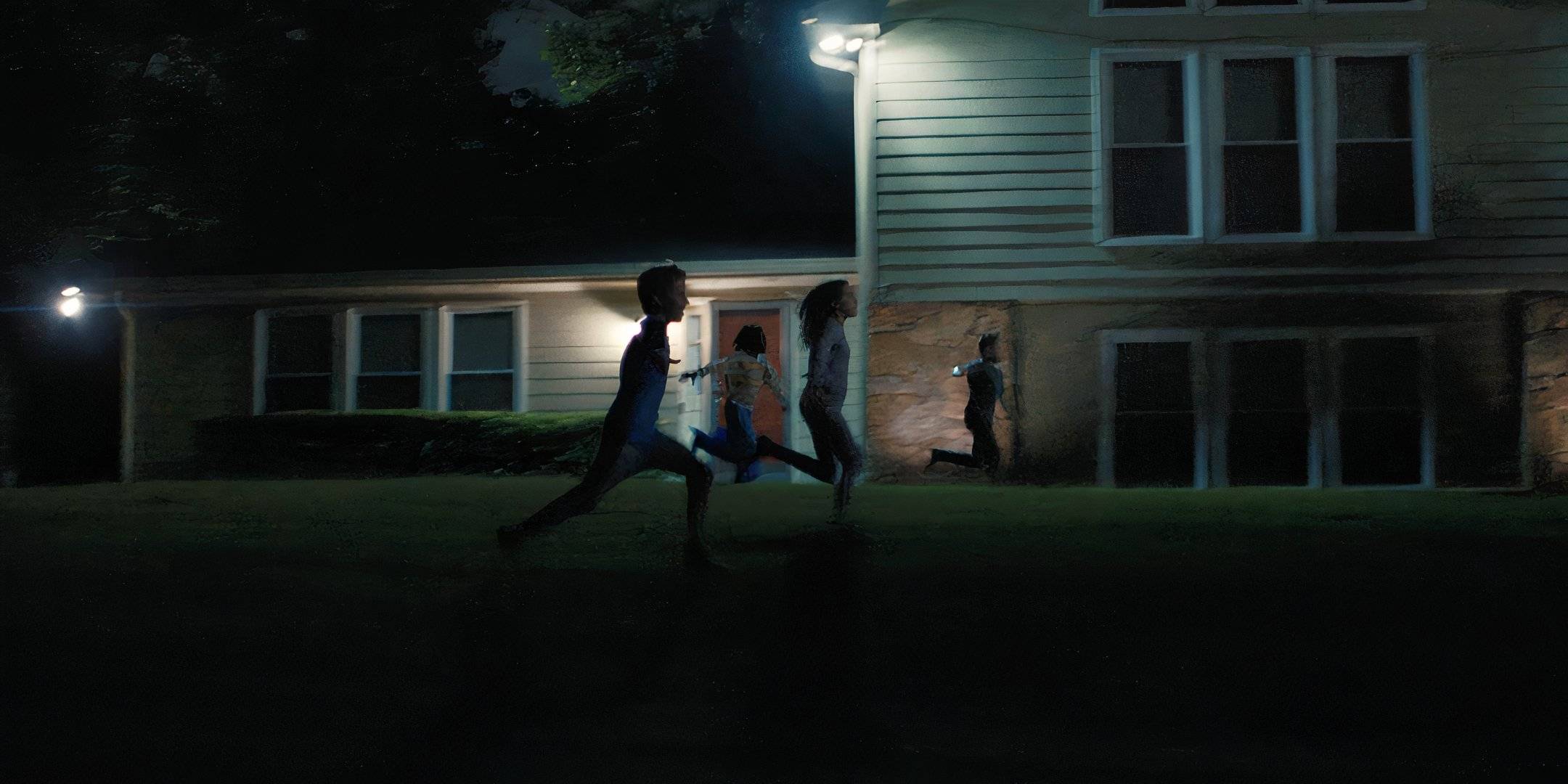 Children running across the front yard of a house in Weapons