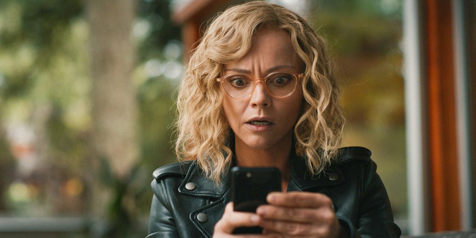 Misty (Christina Ricci) looking at Walter's phone with a shocked expression in Yellowjackets season 3, episode 9