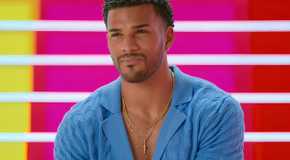 Love Island USA season 7's Jeremiah looking serious against a colorful background