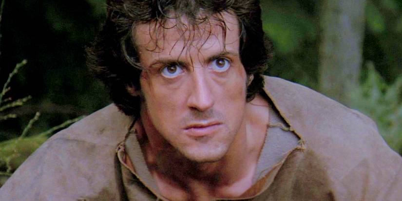 A closeup of Sylvester Stallone as John Rambo with wide eyes in First Blood