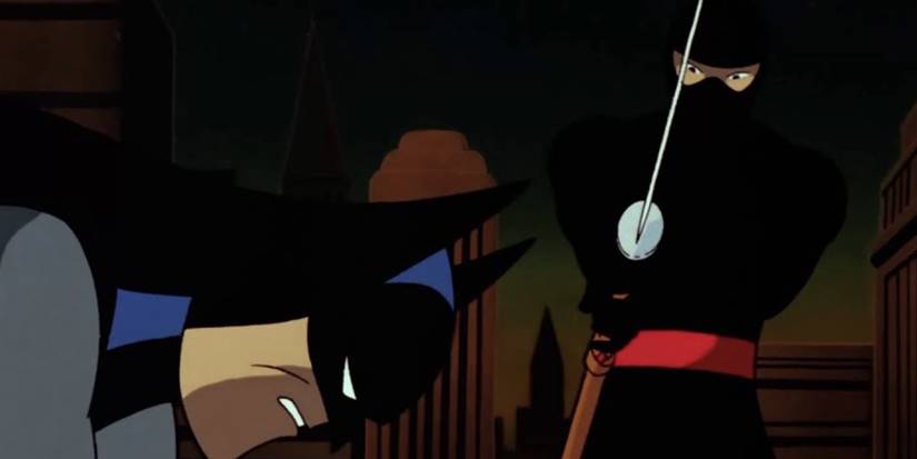 A Ninja stands with a sword over Batman in Batman the animated series Night Of The Ninja