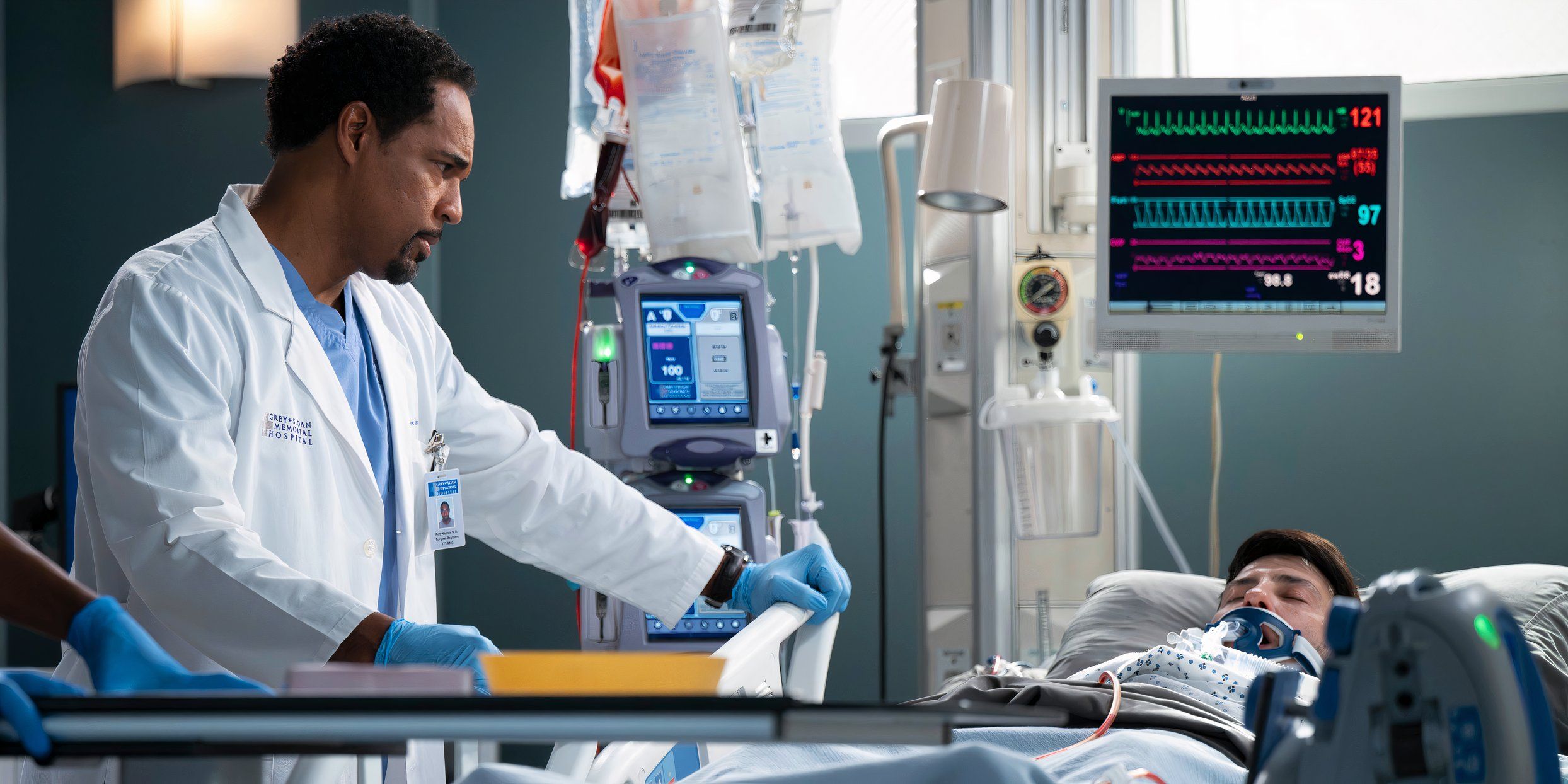 Ben wears a serious expression while looking at a patient in Grey's Anatomy season 21 episode 18