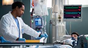 Ben wears a serious expression while looking at a patient in Grey's Anatomy season 21 episode 18