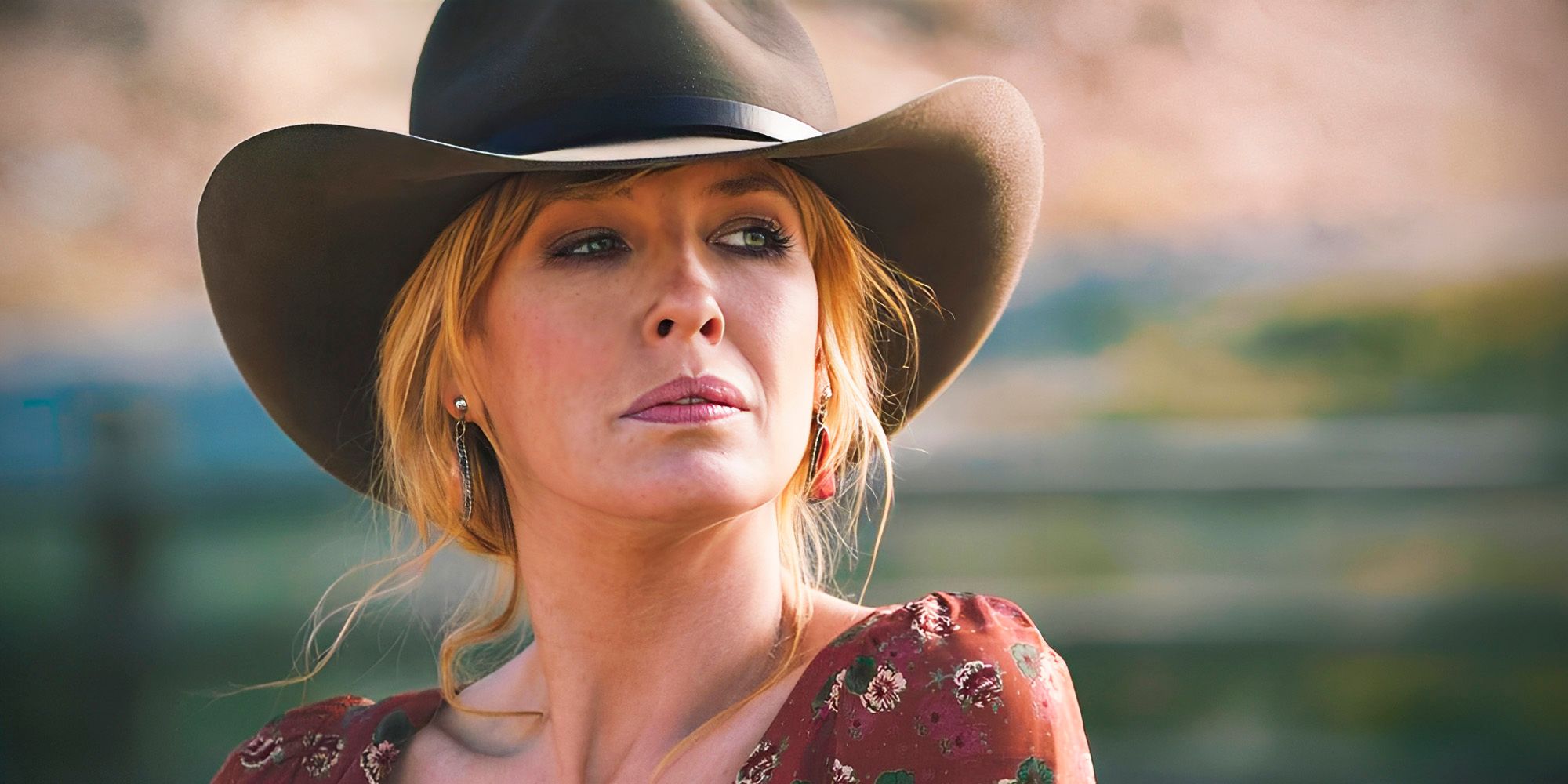 Beth Dutton in Yellowstone in western hat, looking off to the side