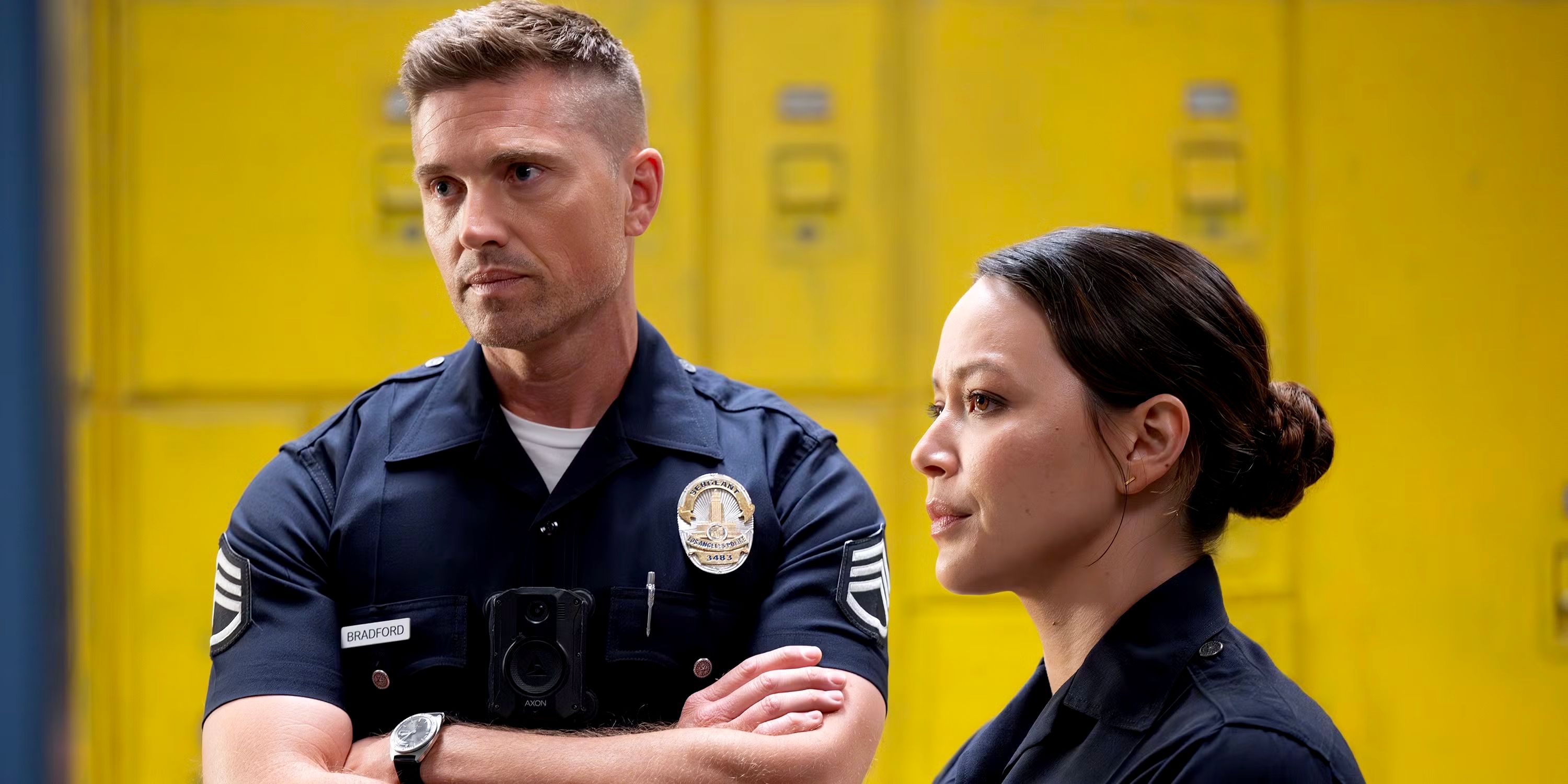 Tim with his arms crossed standing next to Lucy in The Rookie season 7