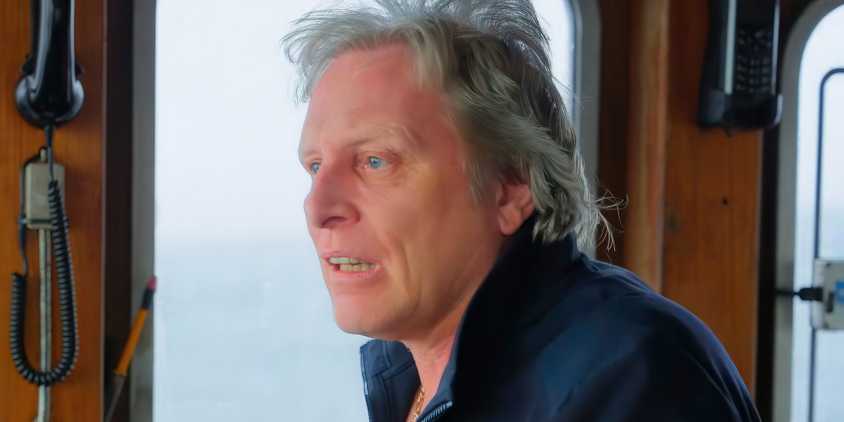 Deadliest Catch captain Sig Hansen looking concerned at the helm of a fishing boat