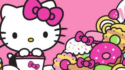 Hello Kitty holds a bucket next to a mountain of candy and pastries