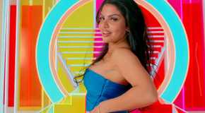 Love Island USA's Huda Mustafa in a blue tube top before a colorful background
