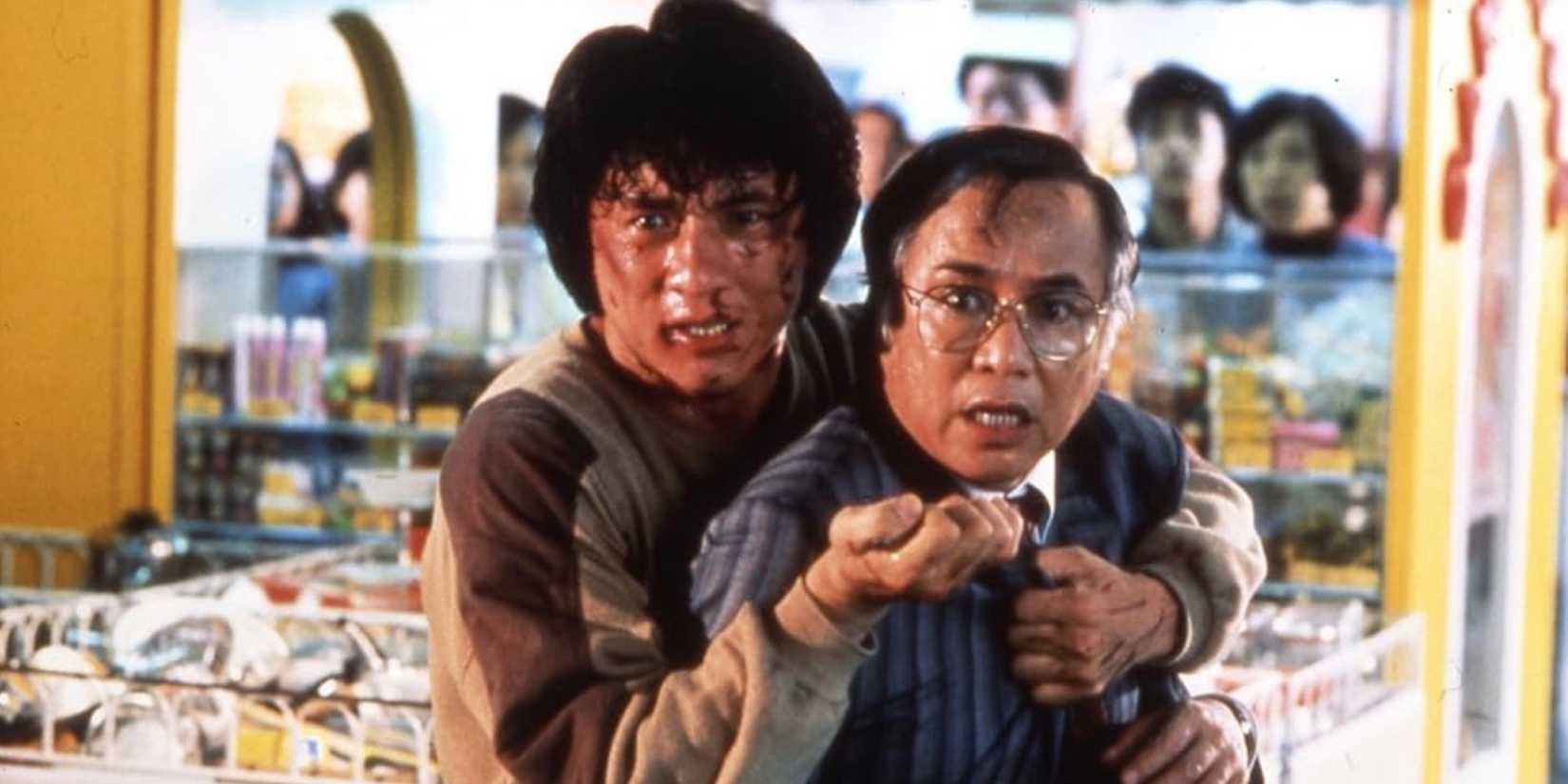 Jackie Chan holds Yuen Chor out in front of him. 