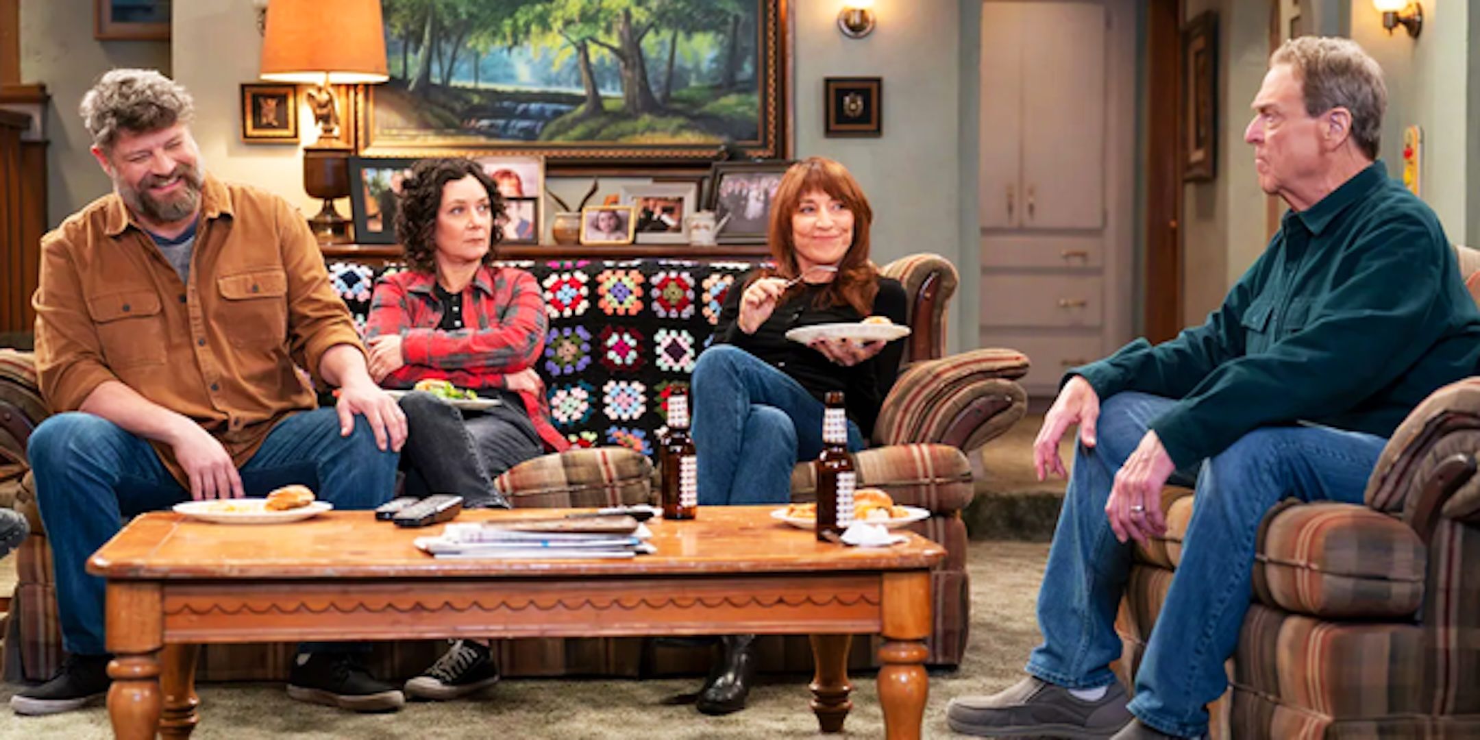Jay R Ferguson's Ben Sara Gilbert's Darlene Katey Sagal's Louise and John Goodman's Dan sit in the living room in The Conners