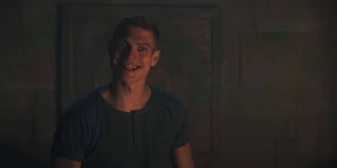Josha Stradowski grins madly at the camera in Wheel of Time season 3 blooper reel