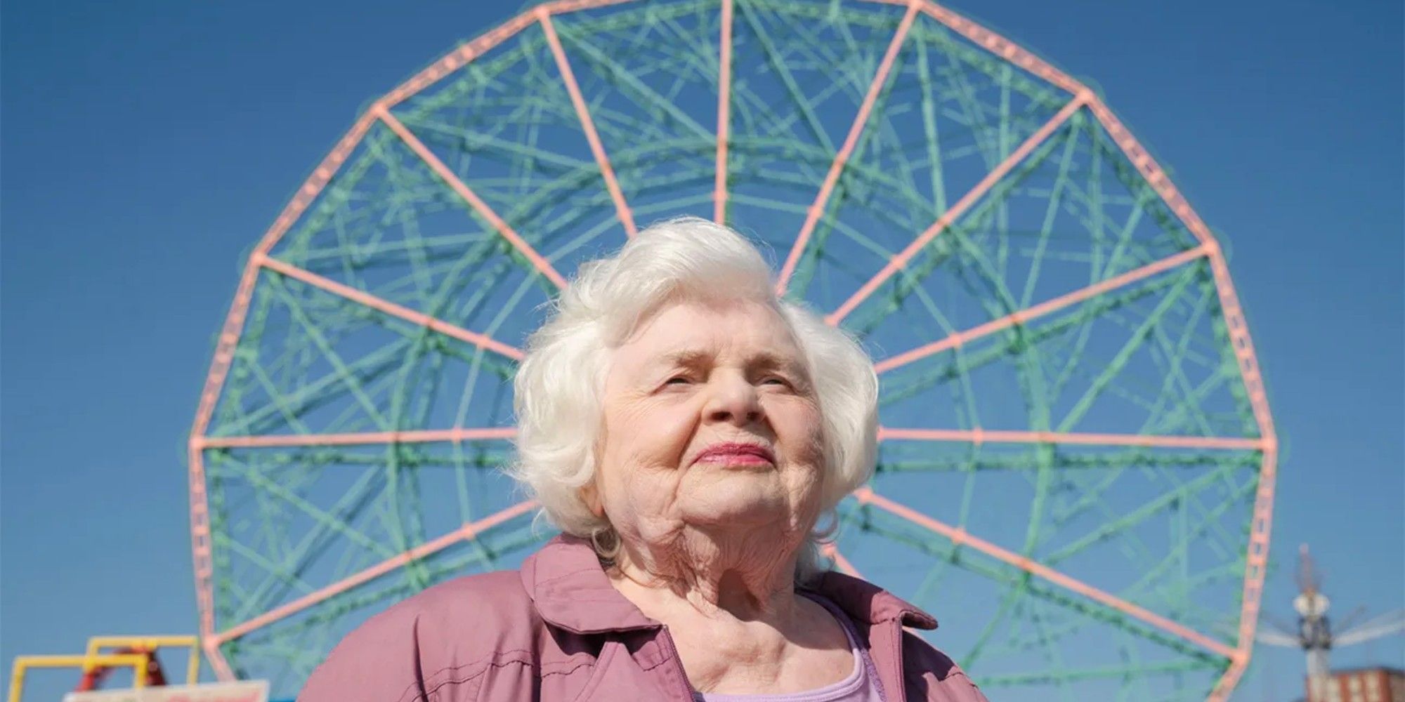 June Squibb stands in front of a ferris wheel in Eleanor the Great